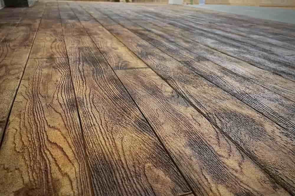 Close-up of a textured wooden floor with natural wood grain patterns.