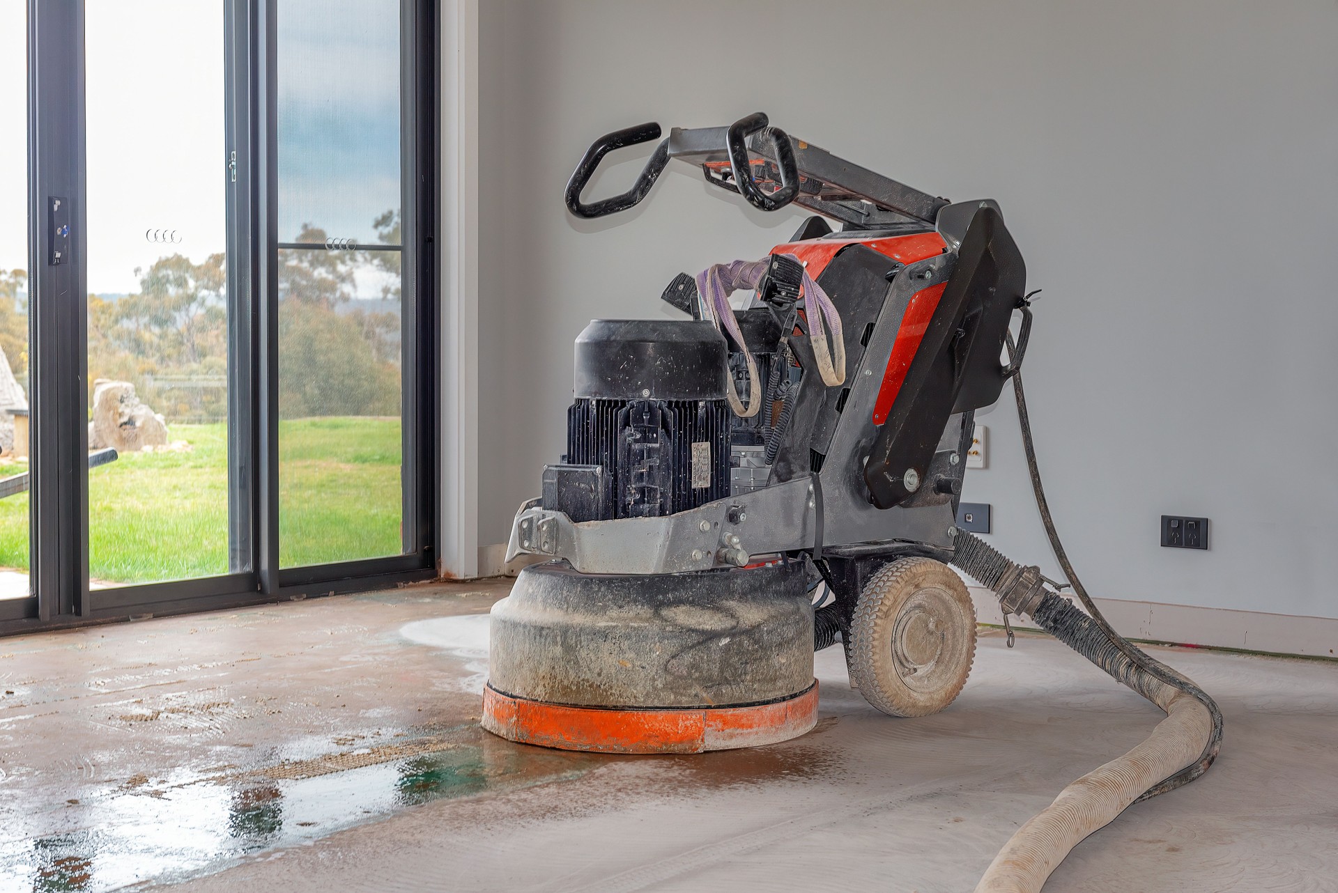 Concrete floor grinding during repair and restoration project in Nashville to remove surface damage and prepare for resurfacing.